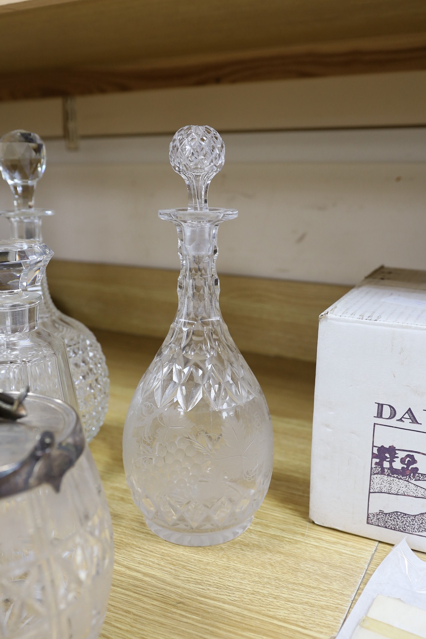A pair of hobnail cut decanters two other pairs of cut glass decanters a single decanter and a glass and plate biscuit barrel